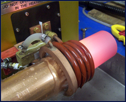 Photo shows copper tube annealing at the end of the heating stroke. Quench ring&rsquo;s water spray is activated to prevent heat zone from moving beyond the required area.